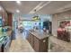 Kitchen island featuring granite countertops and a view of the dining and living areas at 6804 Forkmead Ln, Port Orange, FL 32128