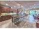 Open concept kitchen with a large granite island, pendant lighting, and stainless steel appliances at 6804 Forkmead Ln, Port Orange, FL 32128