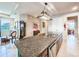 Kitchen island with granite countertops and stainless steel dishwasher, near dining area at 6804 Forkmead Ln, Port Orange, FL 32128