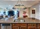 View of kitchen island with sink and stainless steel dishwasher overlooking the living area at 6804 Forkmead Ln, Port Orange, FL 32128