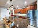 Kitchen area with central island, stainless refrigerator, and modern appliances at 6804 Forkmead Ln, Port Orange, FL 32128
