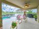 Outdoor lanai with dining area overlooking a pool and serene water view at 6804 Forkmead Ln, Port Orange, FL 32128