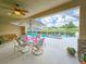 Screened lanai featuring a dining set, ceiling fan, and relaxing view of the pool at 6804 Forkmead Ln, Port Orange, FL 32128