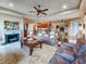 Inviting living room with a fireplace, comfortable seating, and seamless flow to the dining area at 6804 Forkmead Ln, Port Orange, FL 32128