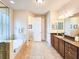Elegant bathroom with a soaking tub, walk-in shower, and double vanity at 6804 Forkmead Ln, Port Orange, FL 32128