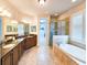 Bathroom featuring double vanity, soaking tub, and walk-in shower at 6804 Forkmead Ln, Port Orange, FL 32128