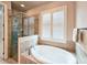 Soaking tub next to a glass shower in this beautifully tiled bathroom at 6804 Forkmead Ln, Port Orange, FL 32128