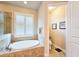 Elegant bathroom with a soaking tub and private toilet area at 6804 Forkmead Ln, Port Orange, FL 32128