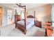 Comfortable main bedroom featuring a four-poster bed, ceiling fan and ensuite bathroom at 6804 Forkmead Ln, Port Orange, FL 32128