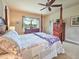 Comfortable main bedroom featuring a four-poster bed and backyard views at 6804 Forkmead Ln, Port Orange, FL 32128