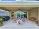 Relaxing covered patio with an umbrella-covered dining table and outdoor seating area at 6804 Forkmead Ln, Port Orange, FL 32128