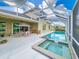 Beautiful screened-in pool area with outdoor dining and a serene backyard view at 6804 Forkmead Ln, Port Orange, FL 32128