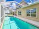 Exterior view of a home featuring a screened pool area and outdoor living space at 6804 Forkmead Ln, Port Orange, FL 32128
