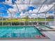Inviting pool with a relaxing view of the tranquil lake, perfect for outdoor enjoyment at 6804 Forkmead Ln, Port Orange, FL 32128