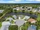 Aerial view of homes with lush landscaping and a pond at 684 Rochester Ct, New Smyrna Beach, FL 32168