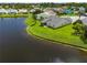 Aerial view of the home on a pond with lush landscaping at 684 Rochester Ct, New Smyrna Beach, FL 32168