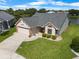 Aerial view of a lovely single-story home with well-manicured landscaping and a two-car garage at 684 Rochester Ct, New Smyrna Beach, FL 32168