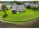 Backyard with large lawn overlooking the lake at 684 Rochester Ct, New Smyrna Beach, FL 32168