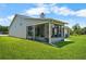 Back of home featuring a screened lanai and a pristine lawn at 684 Rochester Ct, New Smyrna Beach, FL 32168