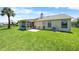 Well-maintained backyard featuring a screened porch and lush green lawn at 684 Rochester Ct, New Smyrna Beach, FL 32168