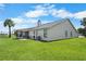 Spacious backyard with well-kept lawn and a screened porch, perfect for outdoor enjoyment at 684 Rochester Ct, New Smyrna Beach, FL 32168