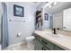 Well-lit bathroom with vanity, mirror, and shower, offering a clean and functional space at 684 Rochester Ct, New Smyrna Beach, FL 32168