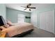 Inviting bedroom with soft lighting, a window, and closet doors for organized storage at 684 Rochester Ct, New Smyrna Beach, FL 32168