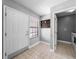 Bright entryway with tiled floor, white door, and a coat rack next to a window at 684 Rochester Ct, New Smyrna Beach, FL 32168