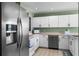 Well-equipped kitchen with stainless steel appliances, white cabinets, and green accent walls at 684 Rochester Ct, New Smyrna Beach, FL 32168