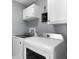 Modern laundry room equipped with a washer and dryer and ample cabinet space at 684 Rochester Ct, New Smyrna Beach, FL 32168