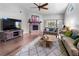 Comfortable living room with brick fireplace and view of the lanai and the backyard at 684 Rochester Ct, New Smyrna Beach, FL 32168