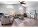 The well-lit living room has vaulted ceilings, a ceiling fan, and views into other parts of the home at 684 Rochester Ct, New Smyrna Beach, FL 32168