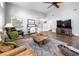 Open living room with wood floors, comfortable seating, and views into the home at 684 Rochester Ct, New Smyrna Beach, FL 32168