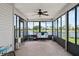 Enclosed patio with comfortable seating overlooking a peaceful lake, perfect for relaxation at 684 Rochester Ct, New Smyrna Beach, FL 32168