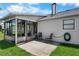 Back patio with outdoor seating and a screened porch, ideal for relaxation at 684 Rochester Ct, New Smyrna Beach, FL 32168