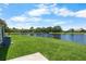 Lush backyard with a serene pond view, enhancing the property's appeal at 684 Rochester Ct, New Smyrna Beach, FL 32168