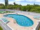 Outdoor pool with inviting blue water, lounge chairs, and white picket fence at 684 Rochester Ct, New Smyrna Beach, FL 32168
