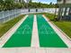 Two shuffleboard courts with the recreation center in the background at 684 Rochester Ct, New Smyrna Beach, FL 32168
