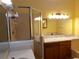 Bright bathroom featuring a glass-enclosed shower, vanity with marble countertop, and ample lighting at 714 Fox Tail Ct, New Smyrna Beach, FL 32168