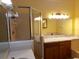 Well-lit bathroom featuring a glass door shower, bathtub, and vanity with marble countertop at 714 Fox Tail Ct, New Smyrna Beach, FL 32168