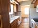 Traditional kitchen featuring wood cabinets, white appliances, and a double basin sink at 714 Fox Tail Ct, New Smyrna Beach, FL 32168