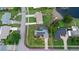 Aerial view of a property with a pool, solar panels, fenced yard, and a waterfront view at 800 Black Duck Dr, Port Orange, FL 32127
