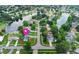 Aerial view of the property featuring a pool, solar panels, and lakeside location in a residential neighborhood at 800 Black Duck Dr, Port Orange, FL 32127