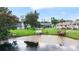 Scenic aerial view of the backyard featuring waterfront access with docks, a pool, and a well-manicured lawn at 800 Black Duck Dr, Port Orange, FL 32127