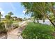 Tranquil backyard featuring a well-maintained lawn, mature trees, and pathway leading to the waterfront at 800 Black Duck Dr, Port Orange, FL 32127