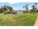 The backyard features a screened-in pool area surrounded by a spacious lawn and mature trees at 800 Black Duck Dr, Port Orange, FL 32127