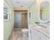 Bathroom featuring updated vanity, tub/shower combo, new tile flooring, and natural light at 800 Black Duck Dr, Port Orange, FL 32127