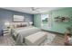 Staged bedroom with neutral walls, area rug, ceiling fan, luxury vinyl flooring, and furniture at 800 Black Duck Dr, Port Orange, FL 32127