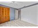 Well-lit bedroom featuring a ceiling fan, light floors, and a closet with wood paneled doors at 800 Black Duck Dr, Port Orange, FL 32127