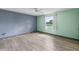 Empty bedroom features updated luxury vinyl flooring, neutral walls, and ample natural light at 800 Black Duck Dr, Port Orange, FL 32127
